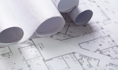 A close up of rolled up blueprints.
