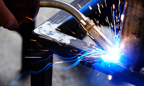 A close up of welding torch being used on steel.